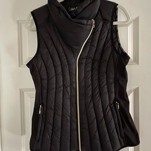Black vest. Off center zipper. Size Medium